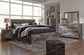 Derekson King Panel Bed with 4 Storage Drawers with Mirrored Dresser, Chest and Nightstand